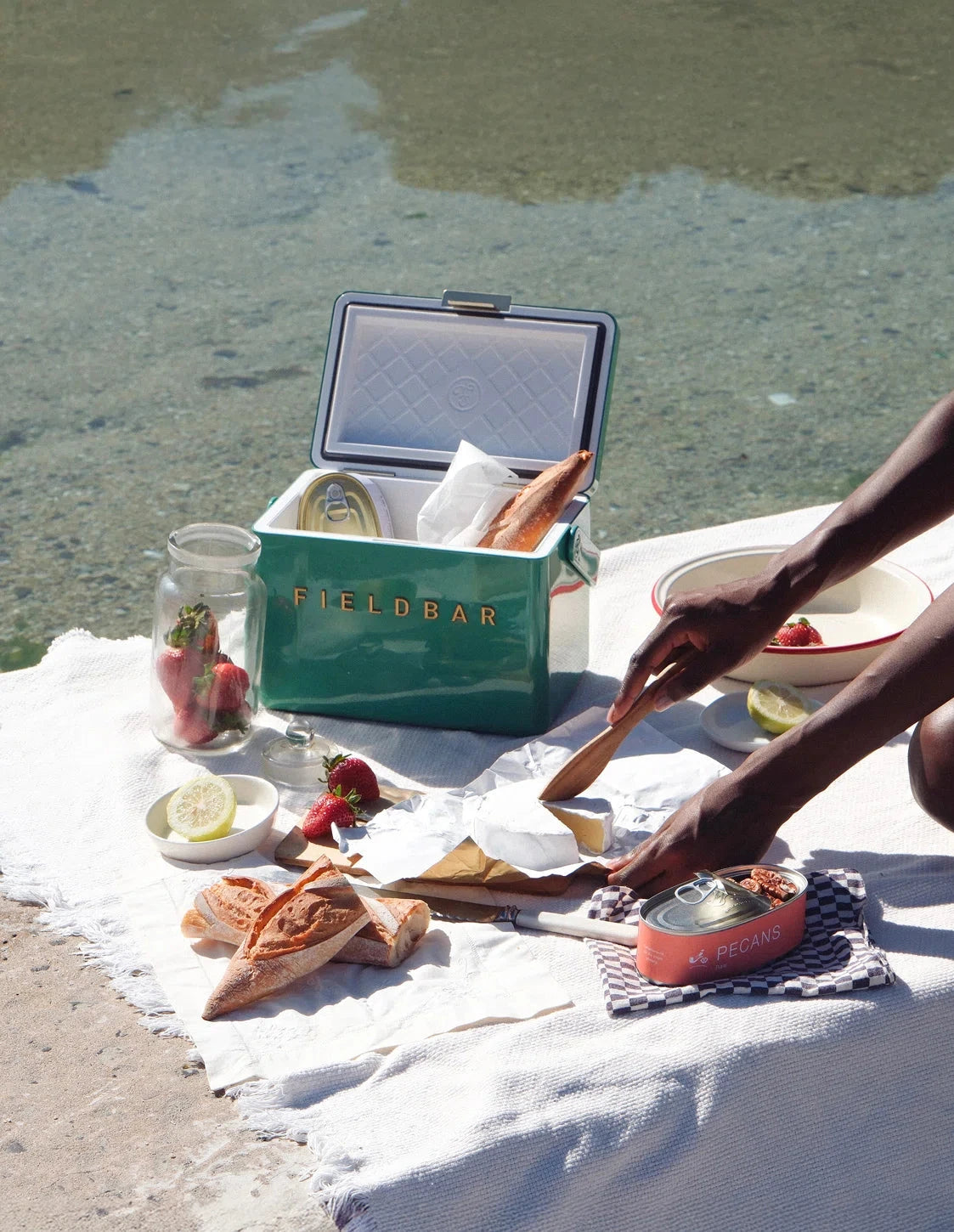 Picnic setup with a FieldBar cooler box by the beach